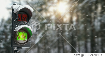 Happy new year 2023. Traffic light with green light 2023  and red 2022 on forest or park background. 95970934