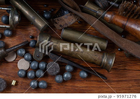 Antique 16-gauge break-action smooth-bored shotgun with brass cases and accessories for cartridge reloading. Antique 16-gauge break-action smooth-bored shotgun with brass cases and accessories for cartridge reloading. 95971276
