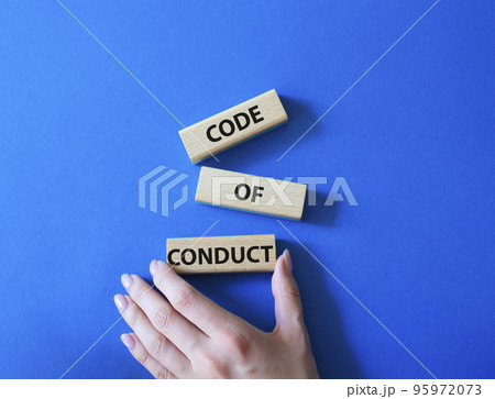 Code of conduct symbol. Wooden blocks with words Code of conduct. Beautiful blue background. Businessman hand. Business and Code of conduct concept. Copy space. 95972073