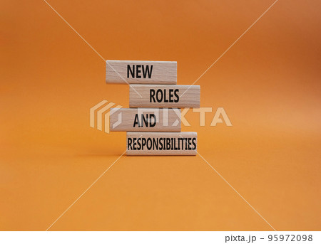 New roles and responsibilities symbol. Wooden blocks with words New roles and responsibilities. Beautiful orangebackground. Business and New roles and responsibilities concept. Copy space. 95972098