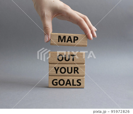 Goals symbol. Wooden blocks with words Map out your goals. Beautiful grey background. Businessman hand. Business and 'Map out your goals' concept. Copy space. 95972826