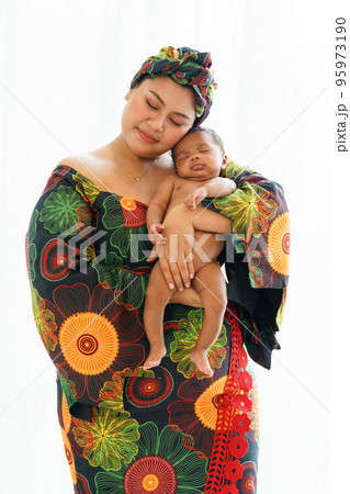 Asian mother in traditional dress native-style African carry newborn baby Asian mother in traditional dress native-style African carry newborn baby 95973190