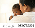 Happy Smiling mother holding adorable newborn baby chubby cheeks 95973354