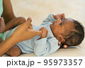 Newborn baby holding fingers mother's hand, Smile relax worry-free. 95973357