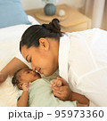 Portrait happy smiling beautiful mother kissing newborn baby 95973360