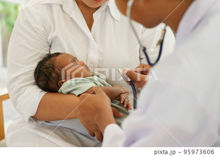 Newborn baby boy visiting the doctor for checkup health 95973606