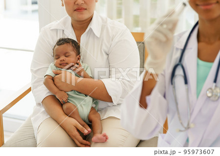 Newborn baby boy visiting the doctor for checkup health 95973607