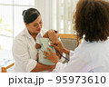 Newborn baby boy visiting the doctor for checkup health 95973610