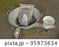 Washing clothes in the traditional way by hand 95973634