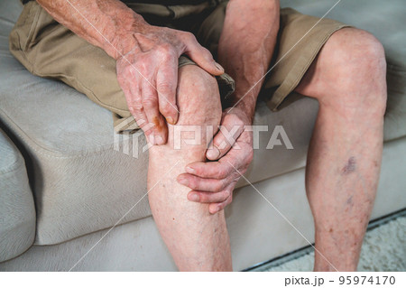 Pain in the legs and knees of an elderly senior 95974170