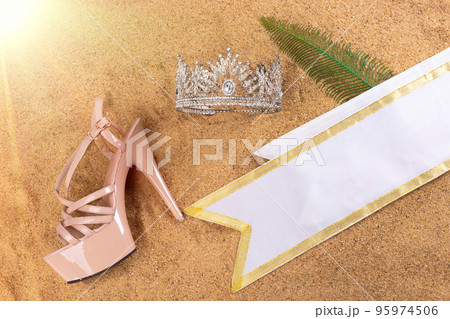 Diamond Crown, High heel shoes, Sash for Princess Miss Pageant Beauty Contest on Sand Beach in Tropical Island beautiful summer sun on golden find sand, studio shot copy space Diamond Crown, High heel shoes, Sash for Princess Miss Pageant Beauty Contest on Sand Beach in Tropical Island beautiful summer sun on golden find sand, studio shot copy space 95974506