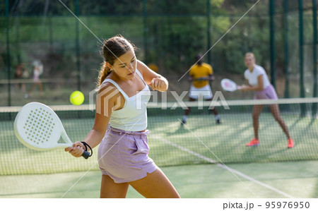 Woman padel tennis player training on court 95976950