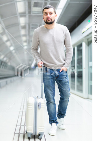 Portrait of confident male passenger in casual clothing on underground platform Portrait of confident male passenger in casual clothing on underground platform 95977047