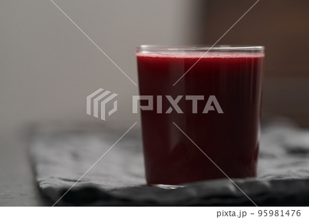 Glass of berry juice on countertop with copy space 95981476