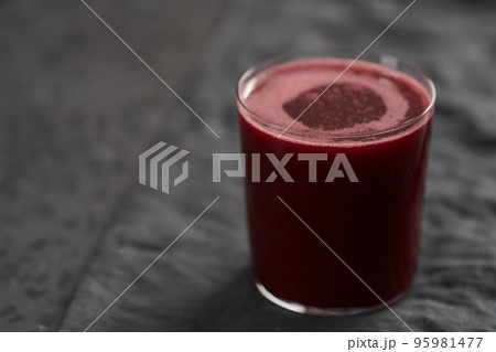 Glass of berry juice on countertop with copy space 95981477