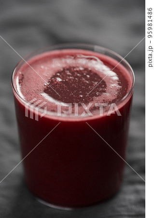 Glass of berry juice on countertop 95981486