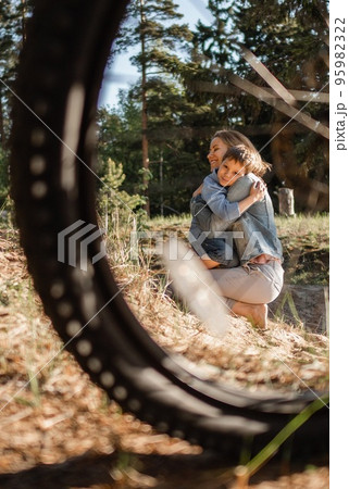 Cute Caucasian boy and happy mother together outdoors 95982322