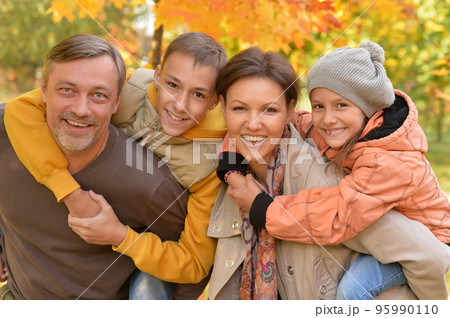 Family with little kids in autumn park on sunny day. Family with little kids in autumn park on sunny day. 95990110