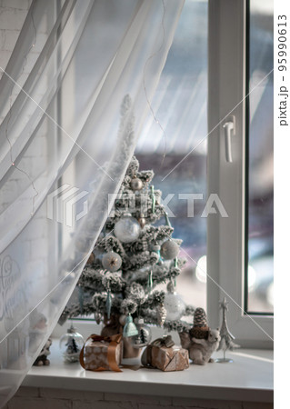 Window sill with New Year's elements - Christmas trees, decorations, Christmas balls. Merry Christmas and Happy New Year greeting card. Cozy background Window sill with New Year's elements - Christmas trees, decorations, Christmas balls. Merry Christmas and Happy New Year greeting card. Cozy background 95990613