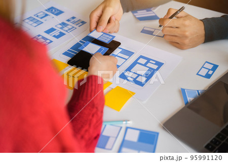 Developer team brainstorming on their project with laptop, smartphone, Creative digital development agency. 95991120