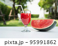Watermelon juice and watermelon slices on the natural background. 95991862