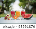 Orange juice, pomegranate juice and watermelon juice on the natural background 95991870