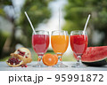 Orange juice, pomegranate juice and watermelon juice on the natural background 95991872