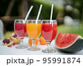 Orange juice, pomegranate juice and watermelon juice on the natural background 95991874