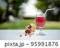 Pomegranate juice with fresh fruit on white wooden table. 95991876