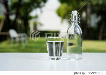 A glass of clean drinking water and a water bottle. A glass of clean drinking water and a water bottle. 95991885