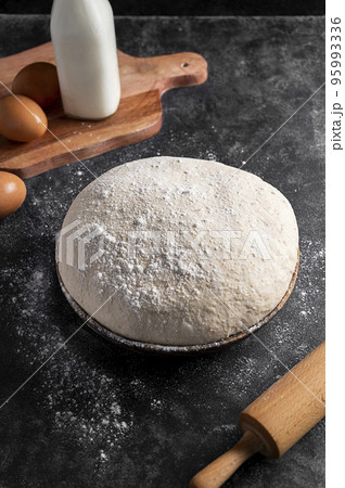 Raw sourdough, dough for homemade baking pizz with milk and eggs. Pastry ingredients 95993336