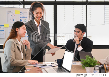 Businesspeople brainstorming new start up ideas, discussing financial paperwork at at briefing 95993611