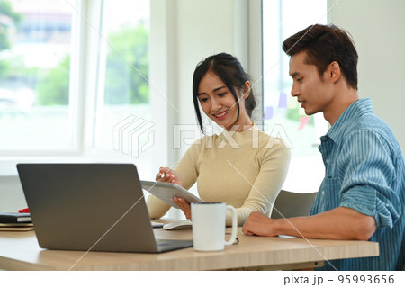 Young creative people brainstorming and preparing presentation for company clients Young creative people brainstorming and preparing presentation for company clients 95993656