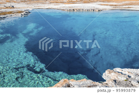 High angle close-up of Sapphire Pool with sky in background. Scenic blue Biscuit basin at Yellowstone National park. Famous sightseeing attraction during sunny day. 95993879