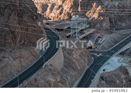 Aerial View Of Cables Over Bridge And Mountain Winding Road At Hoover Dam In Nevada Aerial View Of Cables Over Bridge And Mountain Winding Road At Hoover Dam In Nevada 95993962