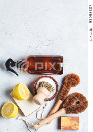 Zero waste eco friendly products and tools for house cleaning. Wooden brushes, coconut sponges, spray vinegar, soda, lemon and organic soap, gray background. Zero waste eco friendly products and tools for house cleaning. Wooden brushes, coconut sponges, spray vinegar, soda, lemon and organic soap, gray background. 95998807