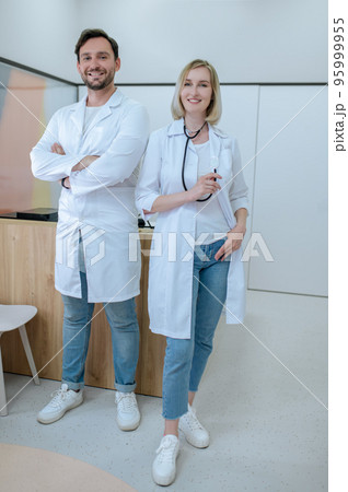 Two doctors in lab coats in the clinic Two doctors in lab coats in the clinic 95999955