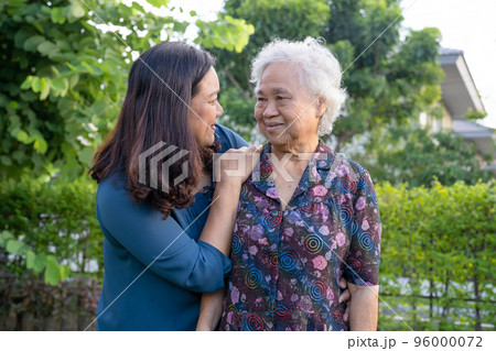 Asian elderly woman with caregiver walking with happy in nature park. Asian elderly woman with caregiver walking with happy in nature park. 96000072