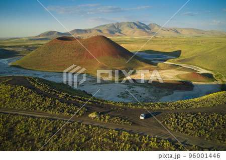 Aerial landscape of Meke Crater in Turkey. View of green valley with the crater lake and the car. Travel destination. 96001446