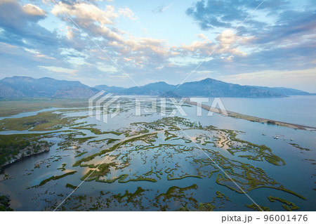 Aerial view of Dalyan river, Iztuzu beach, sea, mountains and lakes. Untouched wild nature landscape of the valley Aerial view of Dalyan river, Iztuzu beach, sea, mountains and lakes. Untouched wild nature landscape of the valley 96001476
