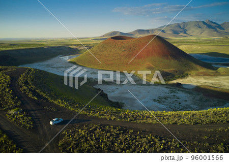Aerial landscape of Meke Crater in Turkey. View of green valley with the crater lake and the car. Travel destination. 96001566
