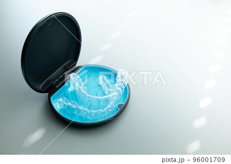 Two invisible dental aligners in the personal box. Orthodontic plastic transparent braces for teeth straightening Two invisible dental aligners in the personal box. Orthodontic plastic transparent braces for teeth straightening 96001709