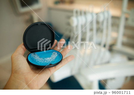 Two invisible dental aligners in the personal box. Orthodontic plastic transparent braces for teeth straightening  96001711