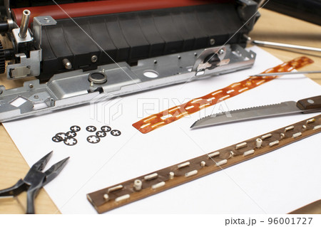 tools and parts lying on a table on a white sheet of paper 96001727