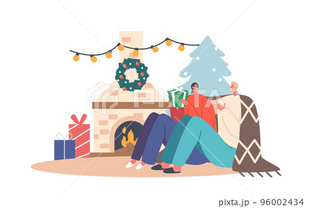 Happy Couple Man and Woman in Warm Cozy Sweaters and Plaid Sitting at Room with Fireplace Exchange Gifts for Christmas 96002434