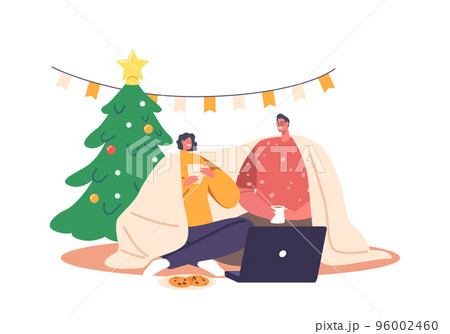 Young Loving Couple Sitting in on Floor Living Room Drinking Tea, Chatting, Watching Movie on Laptop during Christmas 96002460