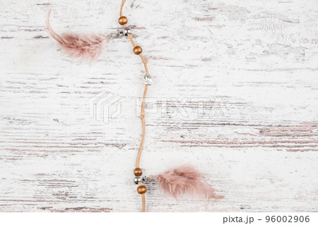 Handmade dream catcher with feathers threads and beads rope hanging on a light background boards 96002906