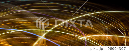 Abstract long exposure original light painting photography. Curvy lines of glowing gold against a black background. Christmas holiday seasonal wallpaper decoration 96004307