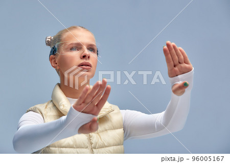 Smart glasses and augmented reality concept. Woman wearing modern spectacles with futuristic screen. Virtual technology. Close up of eye surrounded by business statistics and analytics. Future vision. 96005167