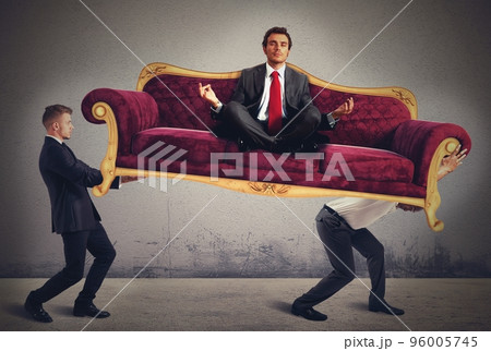 Men carrying a yoga businessman on sofa Men carrying a yoga businessman on sofa 96005745